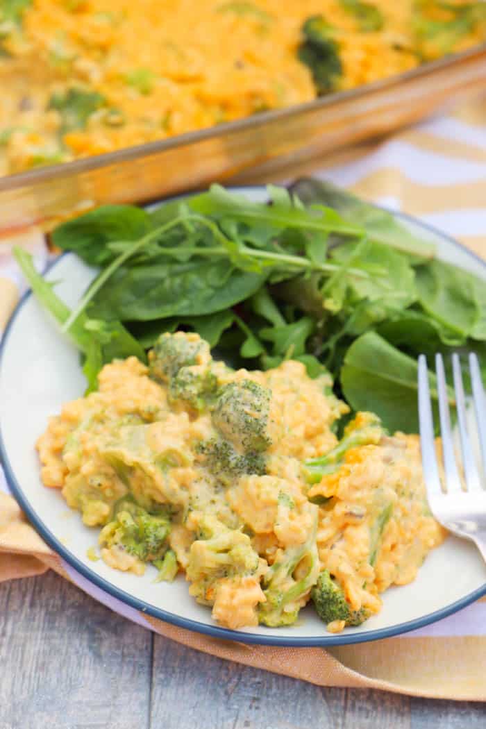 Cheesy Broccoli Casserole on a white plate with a fork