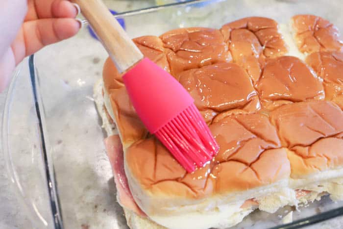 brushing the tops on the Italian Sliders for dinner oil