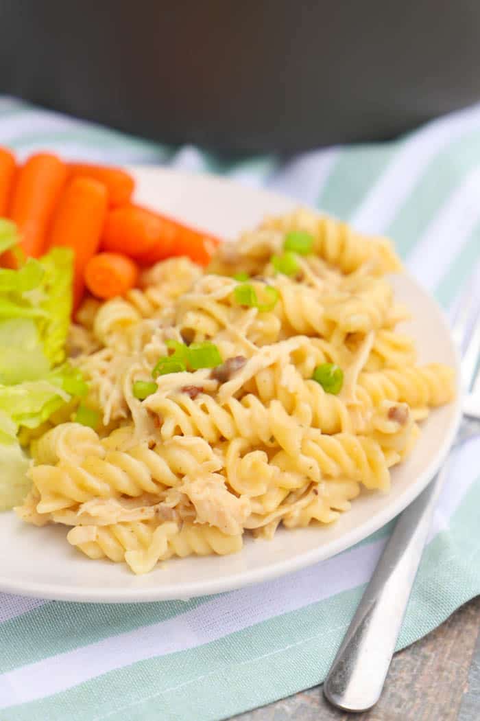 Chicken Bacon Ranch Pasta on a white plate with salad