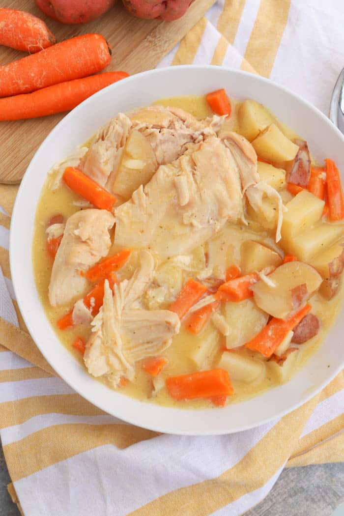 Slow Cooker Creamy Ranch Chicken and Vegetables on a table with a yellow napkin