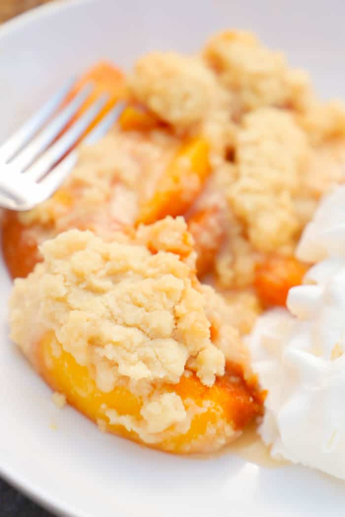 Close up picture of Peach Cobbler with whipped cream