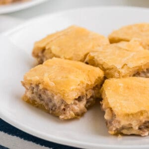 Sausage Cream Cheese Crescent Bake cut into squares on a plate