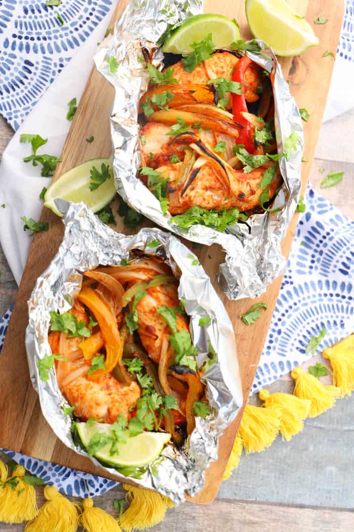 Grilled Chicken Fajitas on a board and in foil