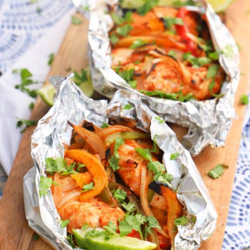 Grilled Chicken Fajitas wrapped in foil and on a napkin