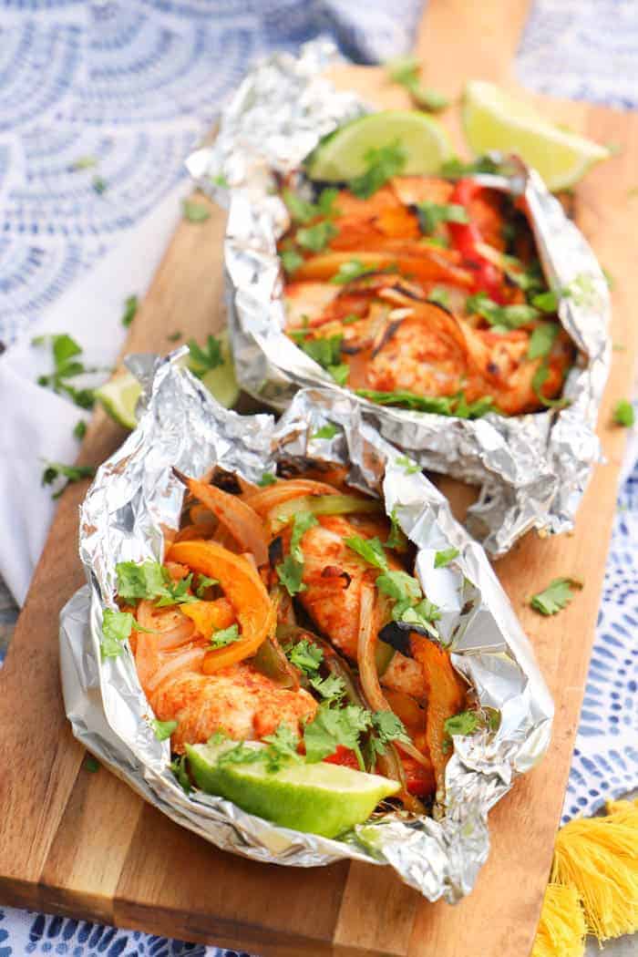 Grilled Chicken Fajitas wrapped in foil and on a napkin