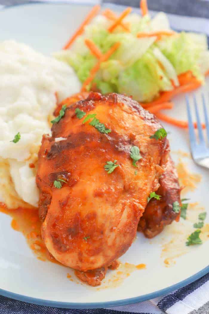 Slow Cooker Catalina Chicken on a plate with mashed potatoes and salad