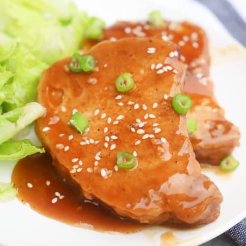 Teriyaki Pork Chops on a white plate with salad