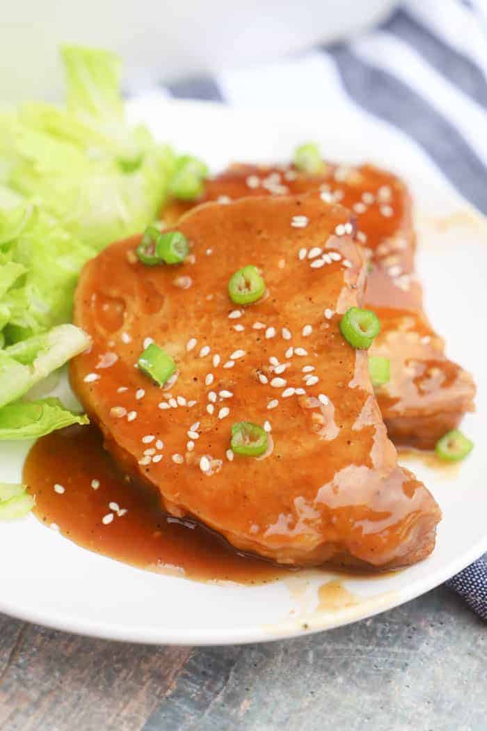 Teriyaki Pork Chops on a white plate with salad