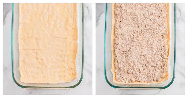 Crescent roll dough pressed into a casserole dish topped with cooked sausage and cream cheese filling