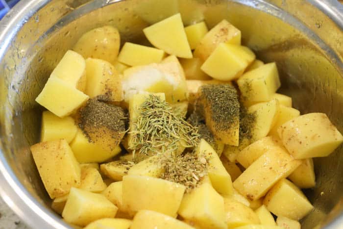 potatoes in a bowl with seasoning