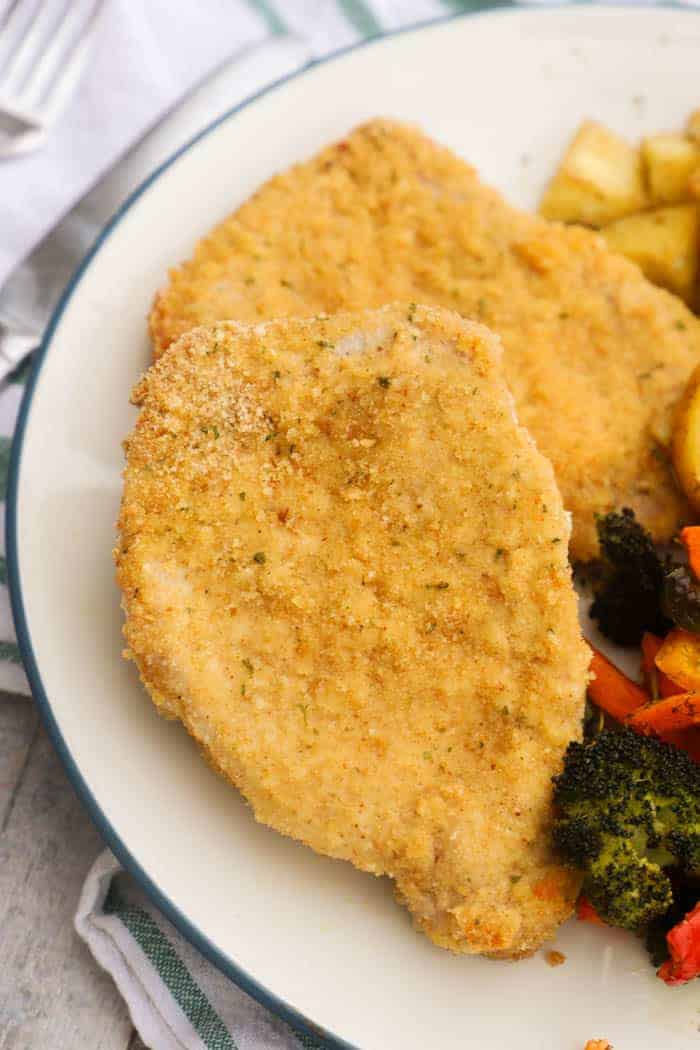 Parmesan Crusted Pork Chops on a white plate