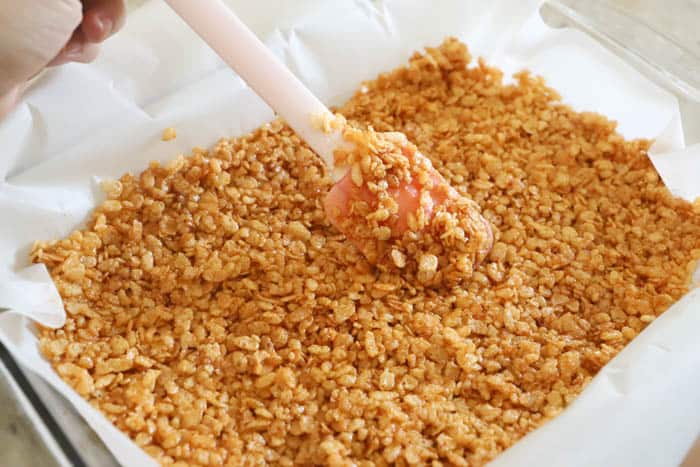 adding Pumpkin Spice Rice Krispies Treats to the pan