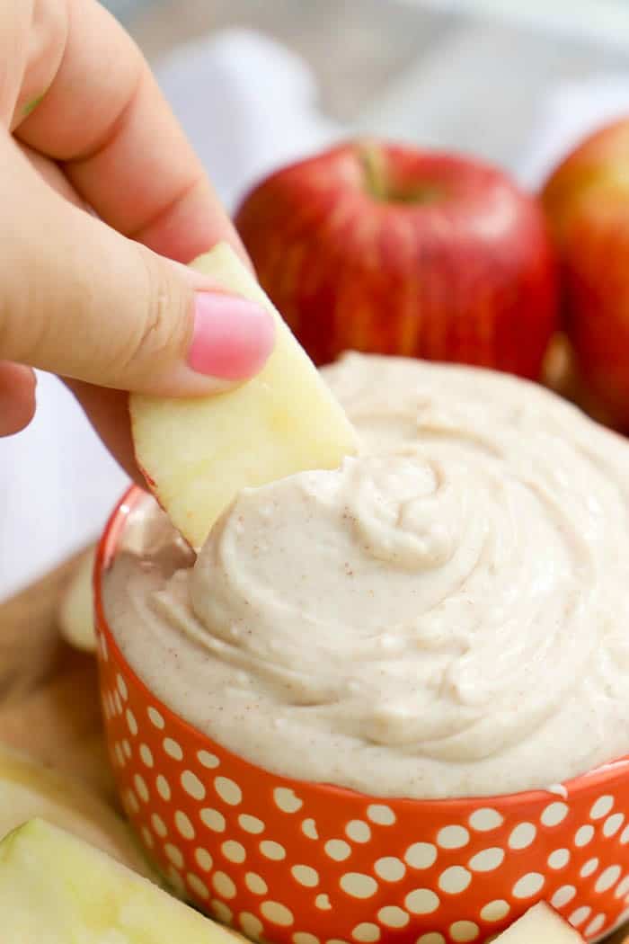 dipping out Snickerdoodle Dip with an apple slice