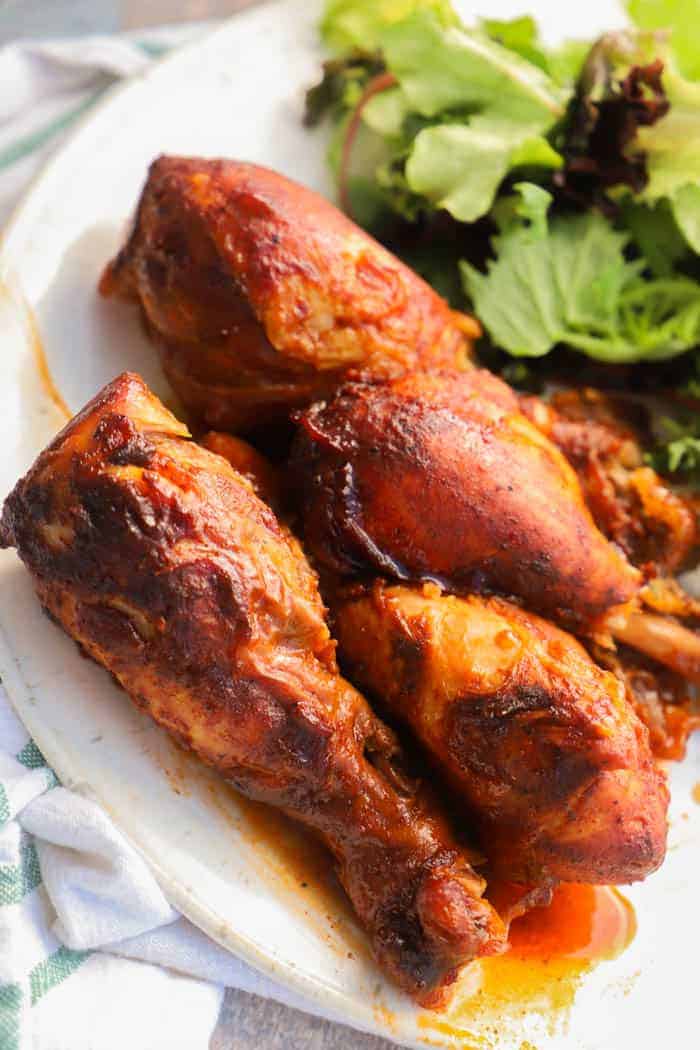 Slow Cooker BBQ Chicken Legs on a plate with salad