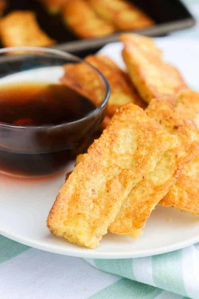 Baked French Toast Sticks on a white plate