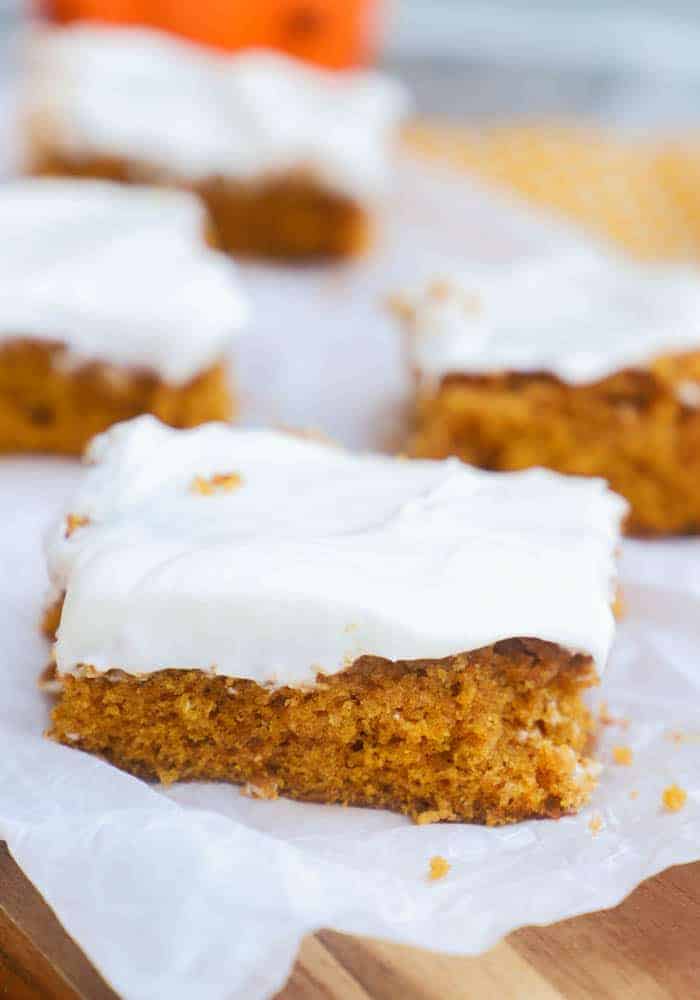 serving Pumpkin Bars on a wooden board