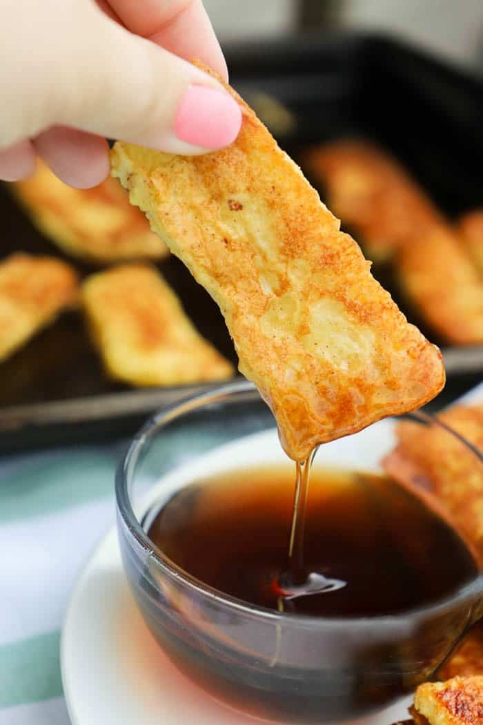 dipping French Toast Sticks in syrup