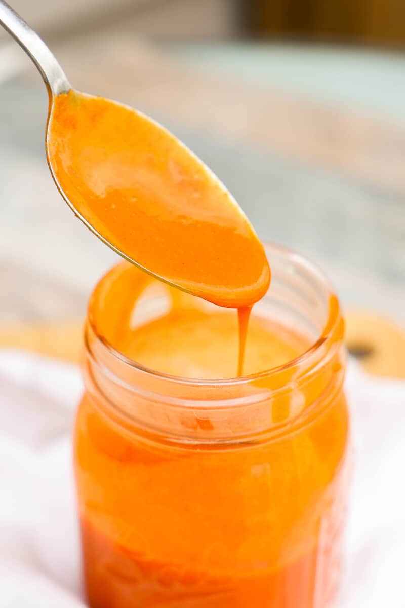 Homemade Buffalo Sauce on a spoon