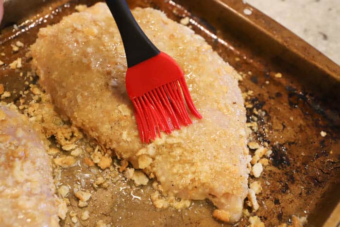 brushing butter onto chicken breast for Ritz Chicken