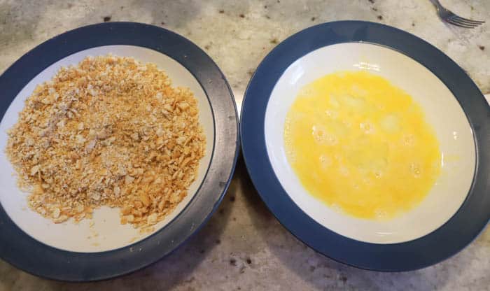 egg and crackers in a mixing bowl. Ritz Chicken