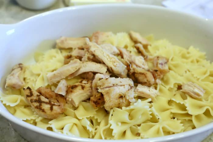 cooked pasta and chicken and placing into the casserole dish