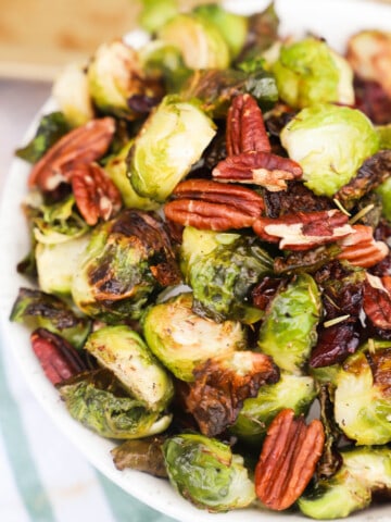 Cranberry Pecan Roasted Brussel Sprouts in a white bowl