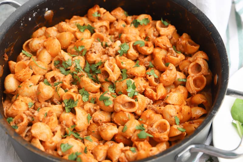 Creamy Ground Beef and Shells in pot topped with parsley