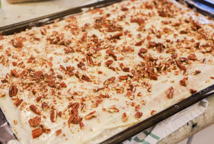 Pumpkin Sheet Cake topped with frosting and pecans