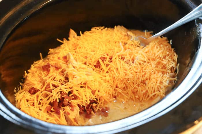 adding cheese to the slow cooker