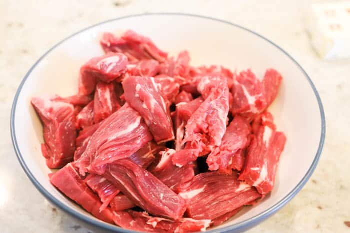 uncooked sliced beef in a bowl