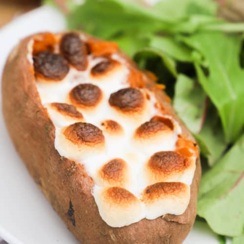 Twice Baked Sweet Potato on a white plate with salad