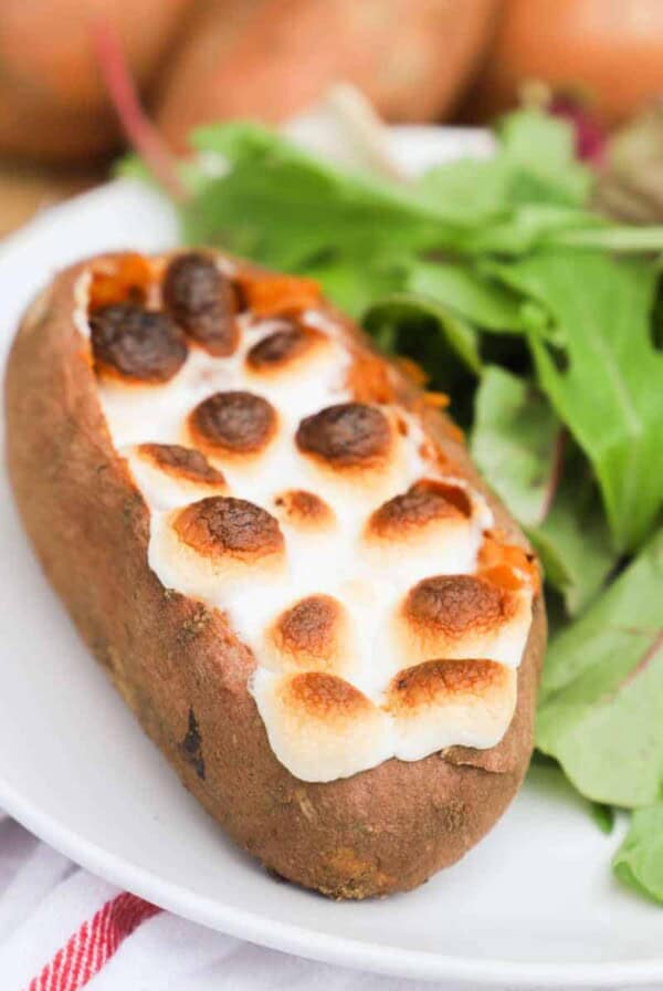 Twice Baked Sweet Potato on a white plate with salad