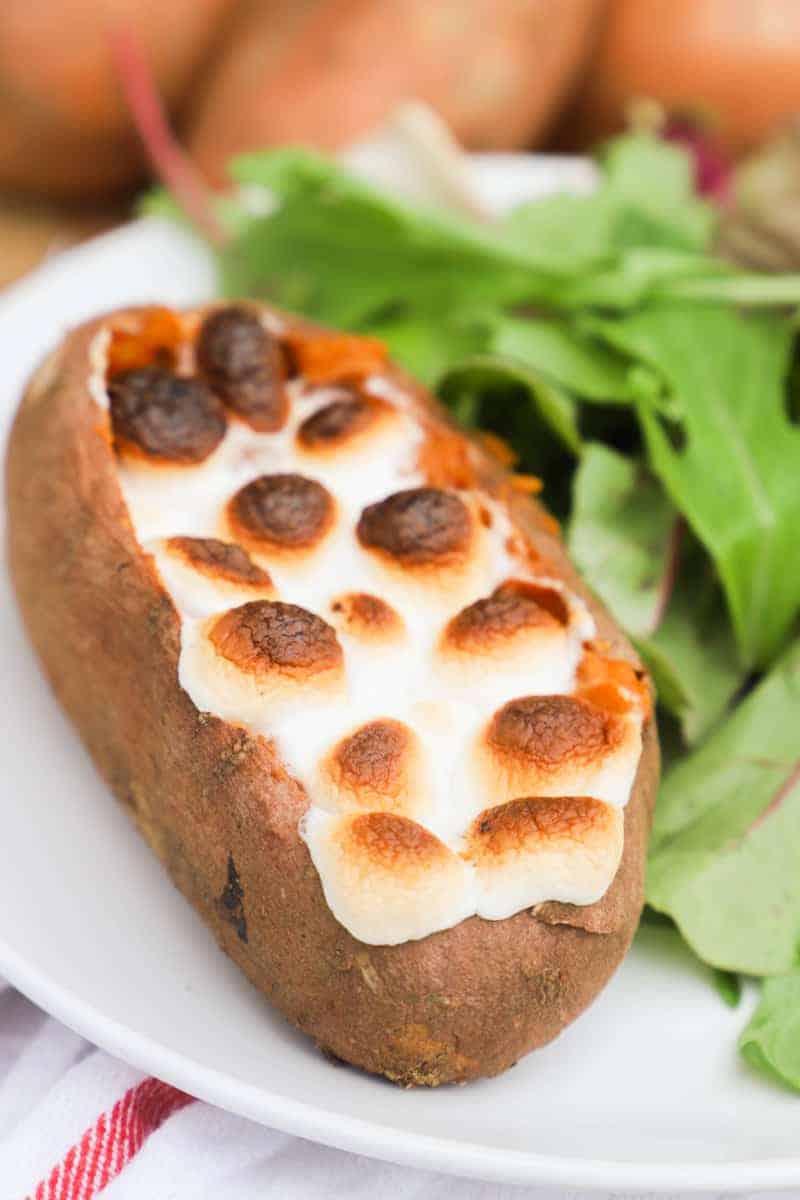 Twice Baked Sweet Potato on a white plate with salad