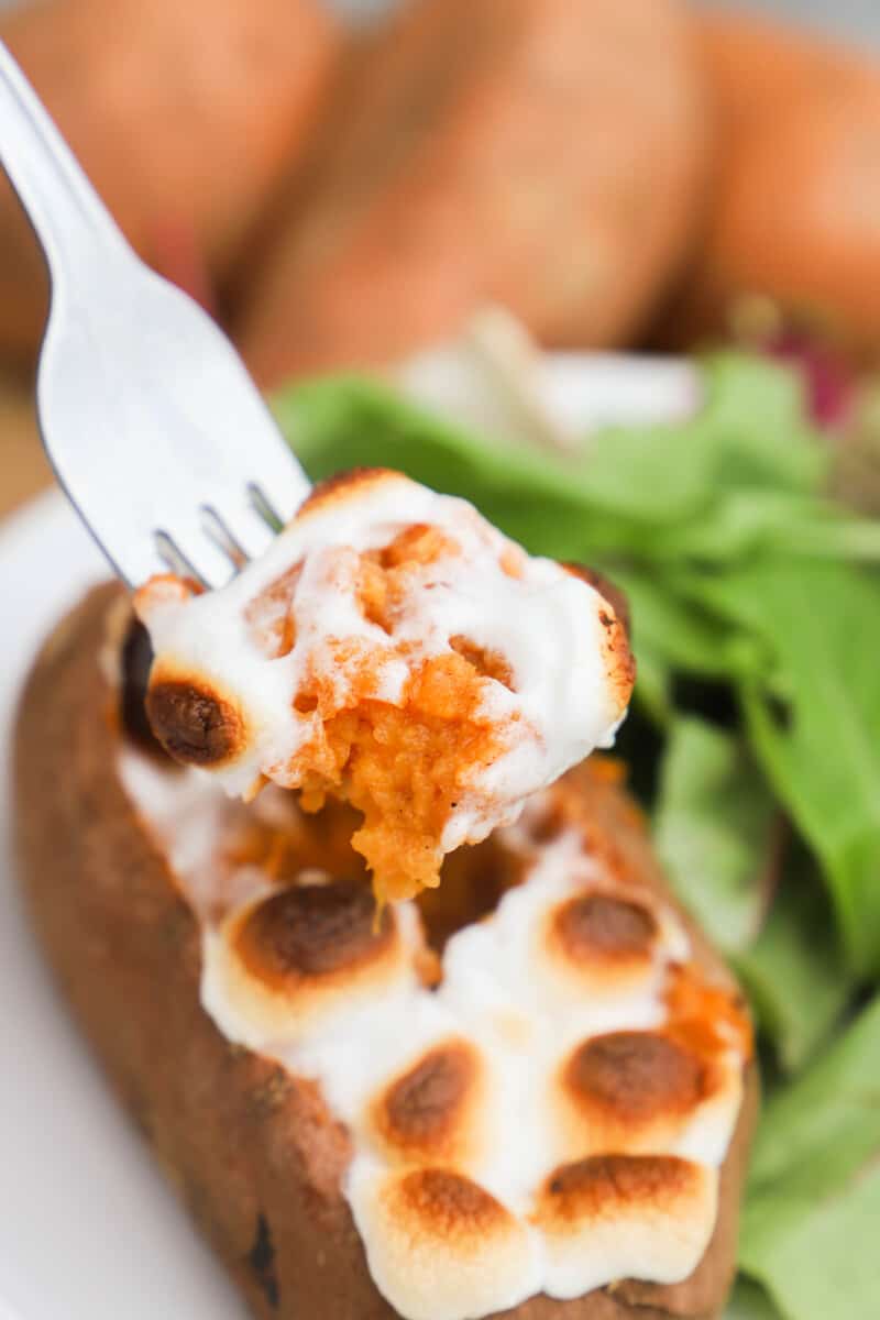 eating Twice Baked Sweet Potato with a fork