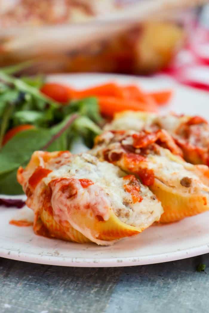 Lasagna Stuffed Shells on a plate with salad