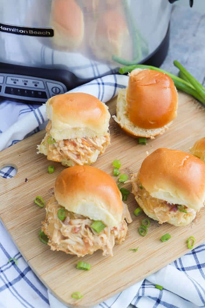 Slow Cooker Chicken Bacon Ranch Sliders on the table with the slow cooker