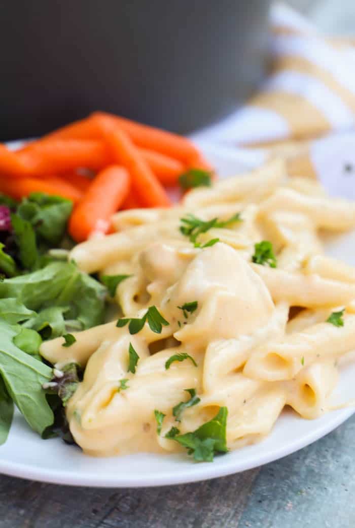 Cheesy Chicken Pasta on a plate with salad