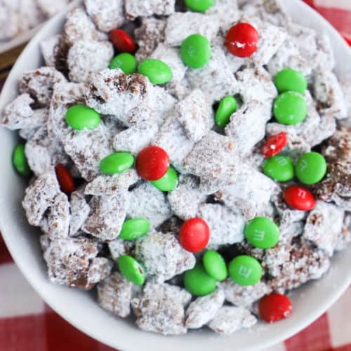 Christmas Puppy Chow in a bowl on a red napkin