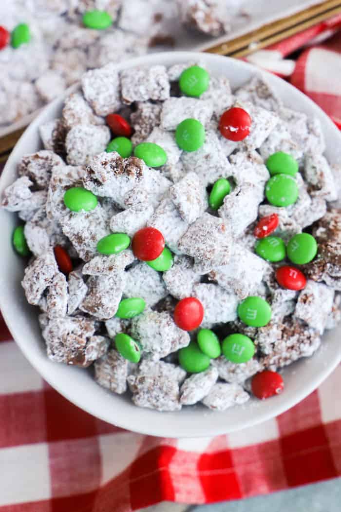 Christmas Puppy Chow in a bowl on a red napkin