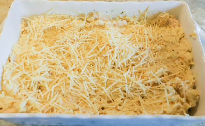 Parmesan Chicken and Rice Casserole in a dish topped with cheese