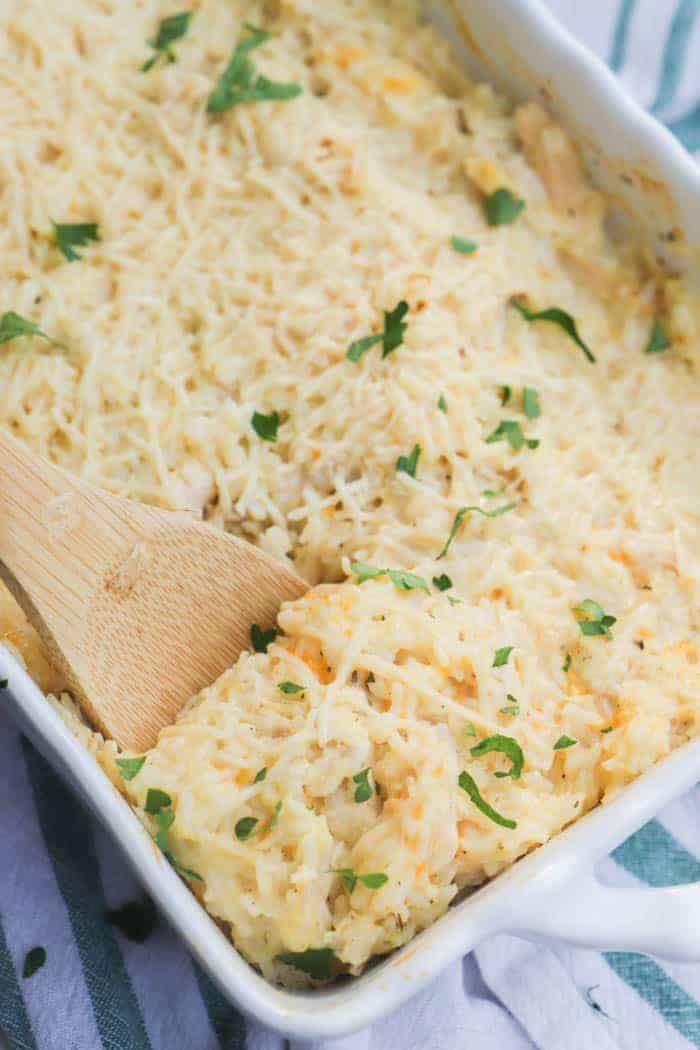 Parmesan Chicken and Rice Casserole on a wooden spoon