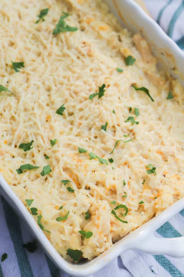 Parmesan Chicken and Rice Casserole in a white casserole dish