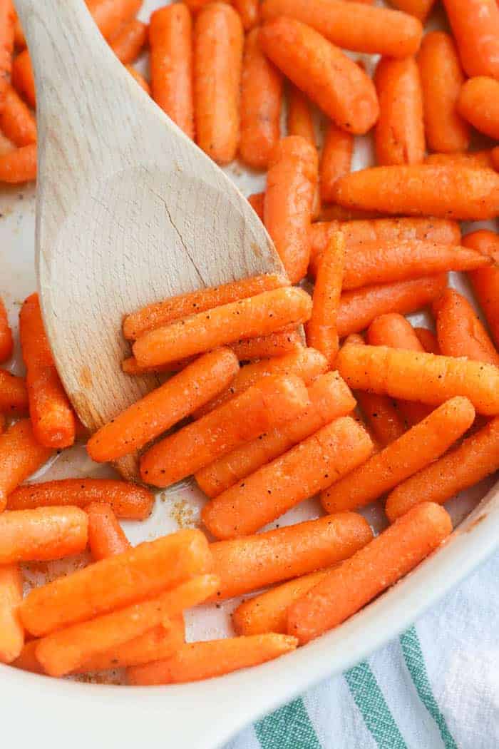 Roasted Carrots Honey with a wooden spoon