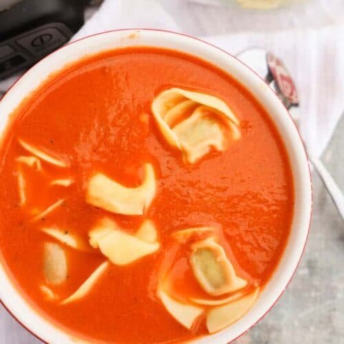 Slow Cooker Tomato Soup and Tortellini in a red bowl