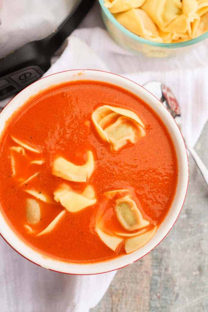 Slow Cooker Tomato Soup and Tortellini in a red bowl