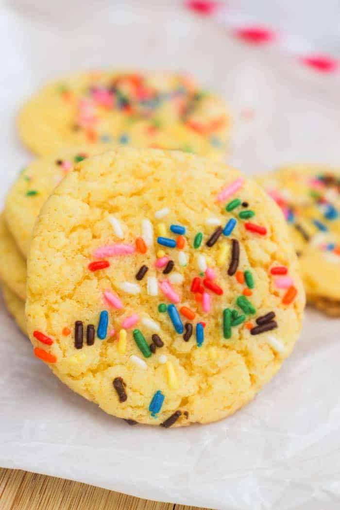 Yellow Cake Batter Cookies on a cutting board with sprinkles