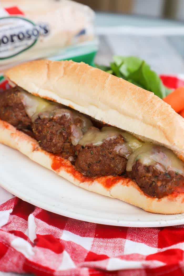 Meatball Subs on a white plate and red napkin