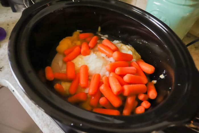 adding chicken and carrots tp the slow cooker