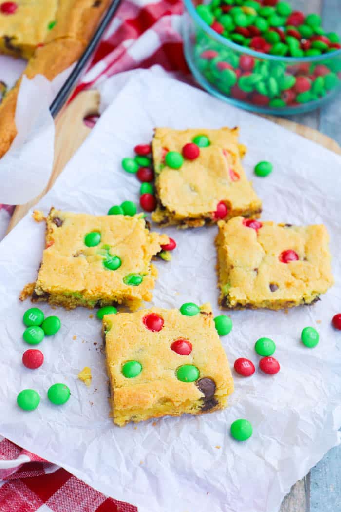 Christmas Cake Mix Bars on parchment paper and M&Ms