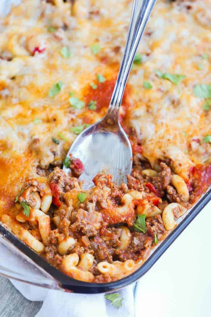 Chili Mac Casserole in a large casserole dish with a spoon